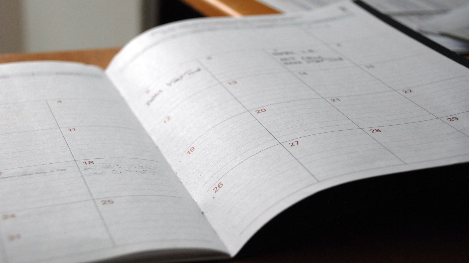 Open monthly planner on a desk for planning next term's GPA target