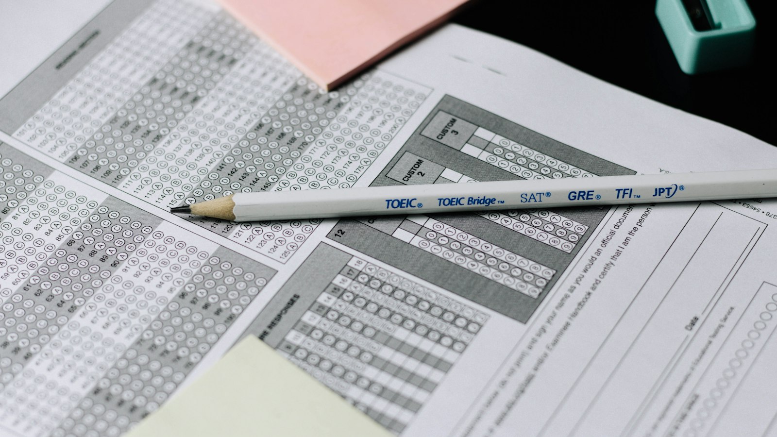 Pencil on a multiple choice answer sheet, representing exam percentage scores